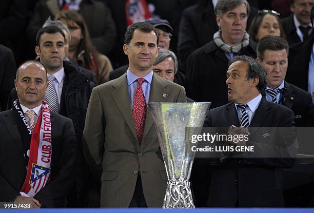 Spain's Prince Felipe congratulates and UEFA President Michel Platini prepare to present the trophy after the final football match of the UEFA Europa...