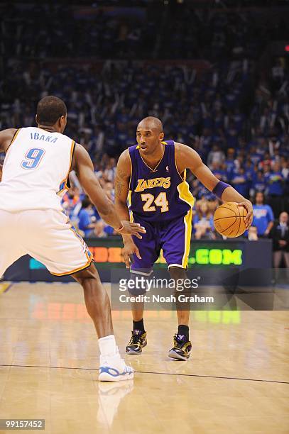 Kobe Bryant of the Los Angeles Lakers dribbles against Serge Ibaka of the Oklahoma City Thunder in Game Six of the Western Conference Quarterfinals...