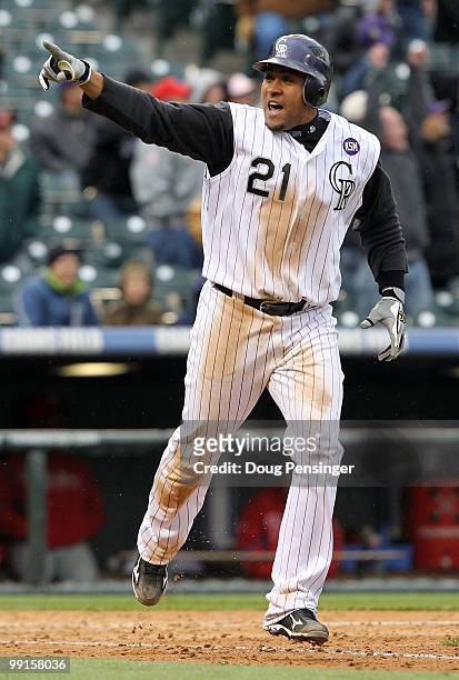 Catcher Miguel Olivo of the Colorado Rockies celebrates as he rounds the bases on his game winning solo homerun off of Chad Durbin of the...