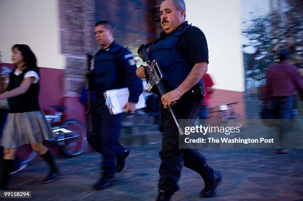 Michoacan In downtown Uruapan police patrol the town square. The drug cartels, including La Familia, have a strong hold in the state of Michoacan,...