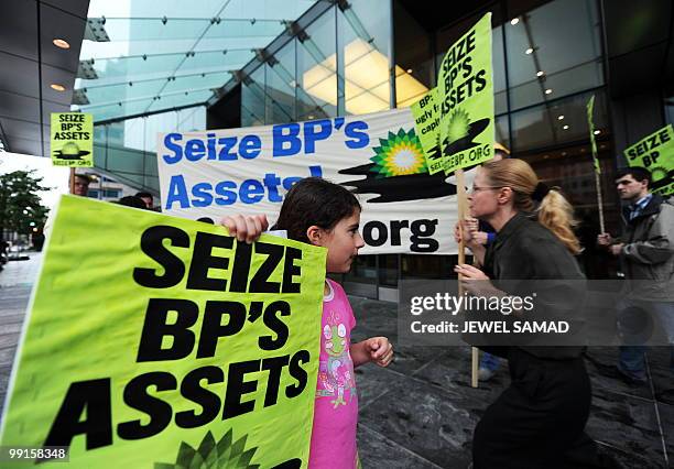 Protesters display placards against BP during a demonstration in front of the BP Amoco Corporation Government Affairs Office in Washington, DC, on...