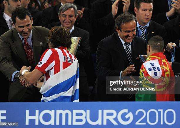 Spain's Prince Felipe and UEFA President Michel Platini congratulate Aletico Madrid's players after the final football match of the UEFA Europa...