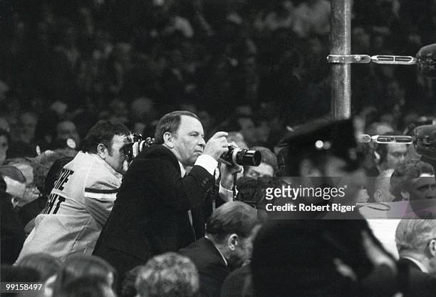 Frank Sinatra photographs the action during the World Heavyweight Championship between Joe Frazier and Muhammad Ali at Madison Square Garden on March...