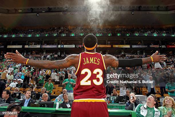 LeBron James of the Cleveland Cavaliers tosses powder into the air before taking on the Boston Celtics in Game Three of the Eastern Conference...