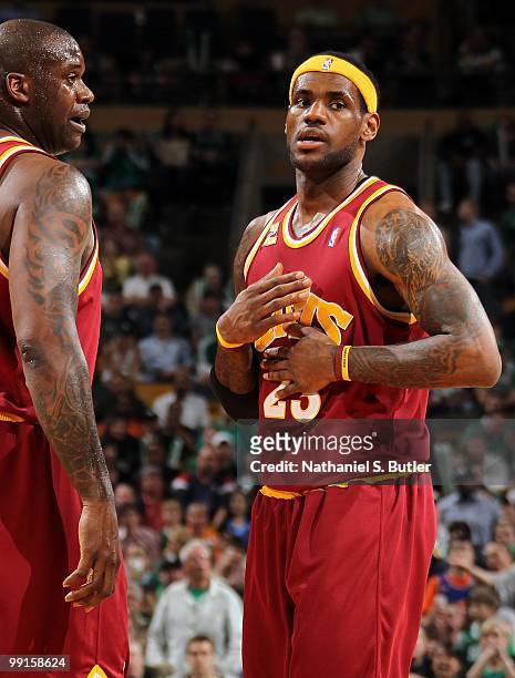 Shaquille O'Neal and LeBron James of the Cleveland Cavaliers stand on the court while taking on the Boston Celtics in Game Three of the Eastern...