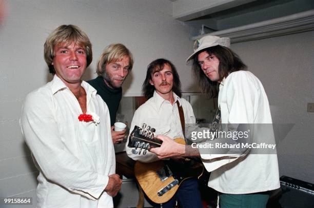 Bob Mosley, Johnny Craviotto, Jeff Blackburn and Neil Young of The Ducks backstage at The Catalyst Club in 1977 in Santa Cruz, California.