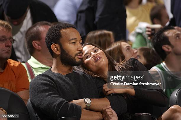 Singer John Legend with girlfriend and Sports Illustrated Swimsuit model Christine Teigen during Boston Celtics vs Cleveland Cavaliers game. Game 4....