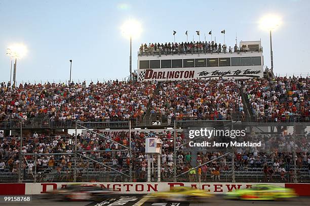 Cars drive past the grandstand at the start of the NASCAR Nationwide series Royal Purple 200 presented by O'Reilly Auto Parts at Darlington Raceway...