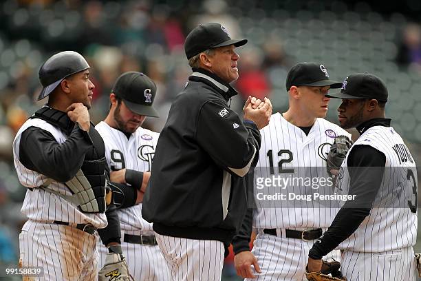 Manager Jim Tracy of the Colorado Rockies awaits relief pitcher Matt Belisle on the mound along with Miguel Olivo, Ian Stewart Clint Barmes and Eric...