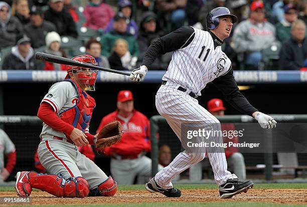 Brad Hawpe of the Colorado Rockies follows through on his two RBI triple to tie the score 3-3 against the Philadelphia Phillies in the seventh inning...