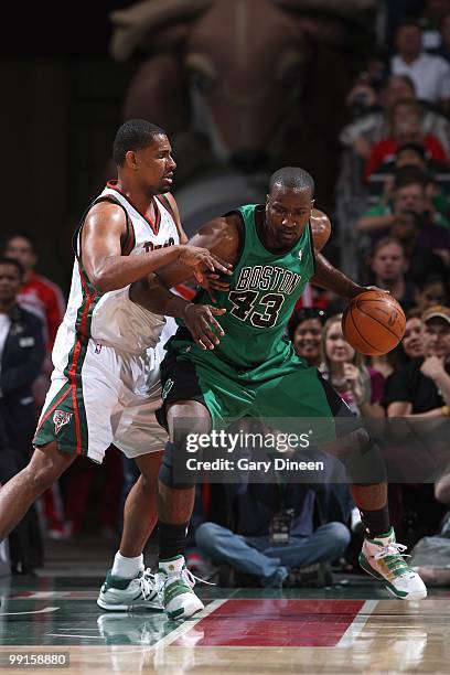 Kendrick Perkins of the Boston Celtics moves the ball to the basket against Kurt Thomas of the Milwaukee Bucks during the game on April 10, 2010 at...