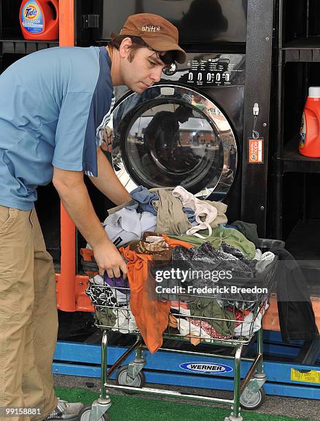 Member of the Tide's Loads Of Hope mobile laundry crew moves clean laundry at Loads of Hope Truck - Laundry Drop-Off Site: Dollar General on May 12,...