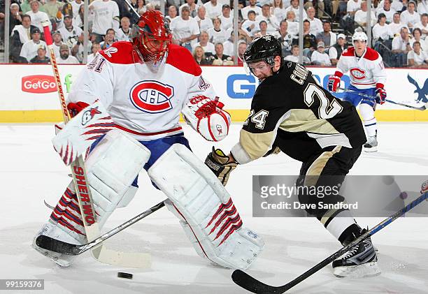 Matt Cooke of the Pittsburgh Penguins battles for a loose puck with Jaroslav Halak of the Montreal Canadiens in Game Seven of the Eastern Conference...