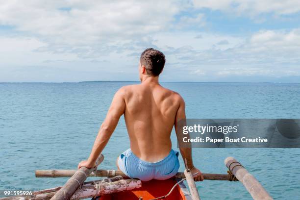 fit man looking in the distance in the beach of puerto princesa, palawan - princesa stock pictures, royalty-free photos & images