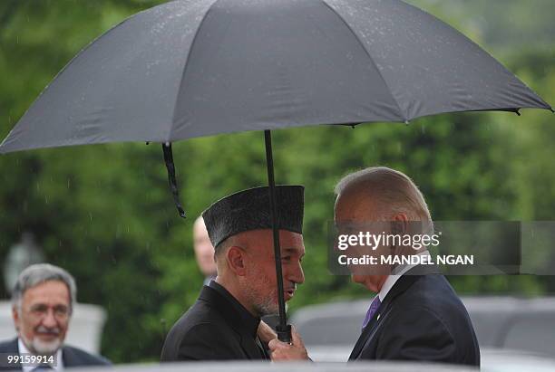 Vice President Joe Biden greets Afghan President Hamid Karzai as he arrive at the US Naval Observatory May 12, 2010 in Washington, DC. Karzai is...