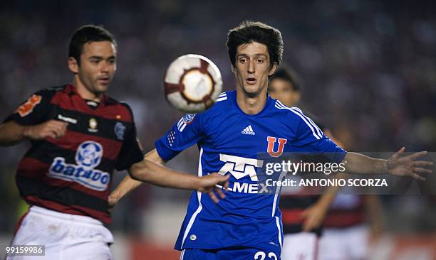 Universidad de Chile player Alvaro Fernandez vies for the ball with Flamengo's Wiliams during their Libertadores Cup quarterfinal football match on...