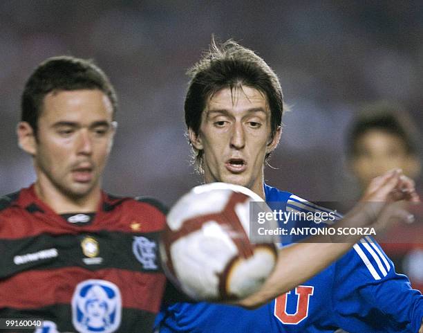 Universidad de Chile's Alvaro Fernandez vies for the ball with Brazilian Flamengo's Wiliams during their Libertadores Cup quarterfinal football match...