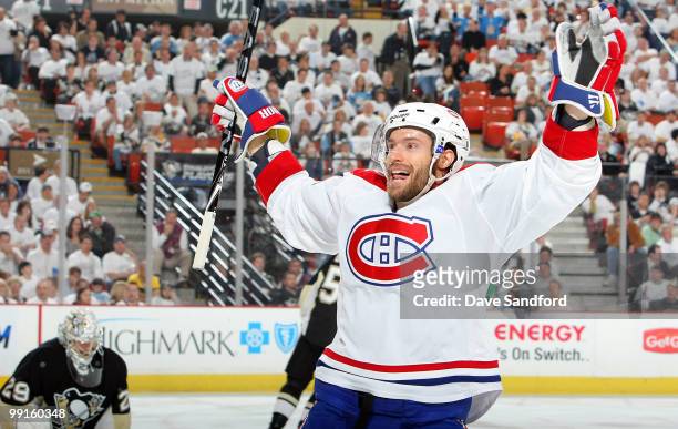 Dominic Moore of the Montreal Canadiens celebrates his team's fourth goal against the Pittsburgh Penguins scored by teammate Travis Moen as...