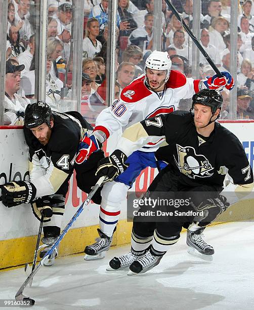 Maxim Lapierre of the Montreal Canadiens tries to split between defencemen Mark Eaton and Brooks Orpik of the Pittsburgh Penguins in Game Seven of...