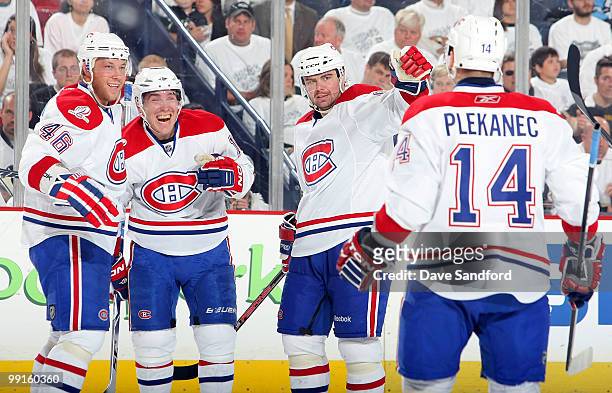Mike Cammalleri of the Montreal Canadiens celebrates his second-period goal against the Pittsburgh Penguins with teammates Andrei Kostitsyn, Jaroslav...
