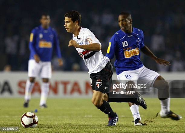 Sao Paulo's player Hernanes dribbles past Cruzeiro' Gilberto during Libertadores quarterfinal football match in Belo Horizonte, Minas Gerais, on May...