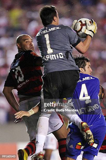 Adriano of Flamengo fights for the ball with players of Universidad de Chile during a match as part of Libertadores Cup at Maracana Stadium on May...