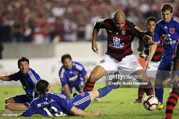 Adriano of Flamengo fights for the ball with players of Universidad de Chile during a match as part of Libertadores Cup at Maracana Stadium on May...