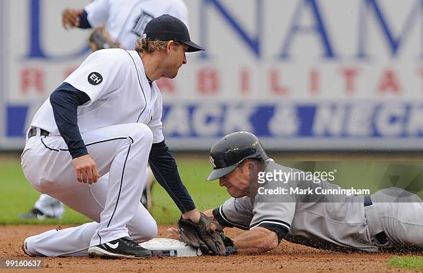 Brett Gardner of the New York Yankees slides safely into second base while Adam Everett of the Detroit Tigers makes the tag during the third inning...