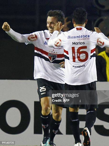 Dagoberto of Brazilian Sao Paulo, celebrates with teammate Marlos, his goal against Brazilian Cruzeiro during their Copa Libertadores quarterfinal...