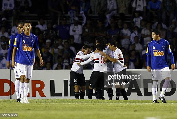 Sao Paulo's player Dagoberto celebrates with teammaet after scoring against Cruzeiro during their Libertadores quarterfinal football match in Belo...