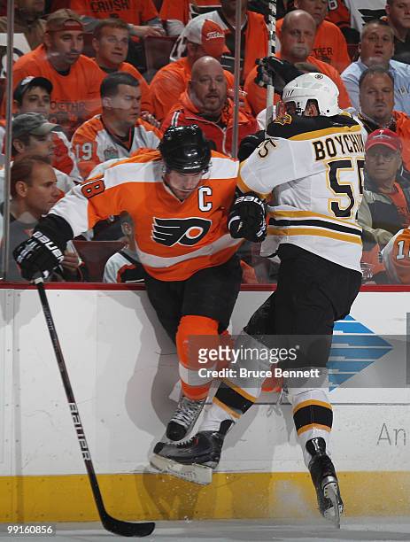 Johnny Boychuk of the Boston Bruins hits Mike Richards of the Philadelphia Flyers in Game Six of the Eastern Conference Semifinals during the 2010...