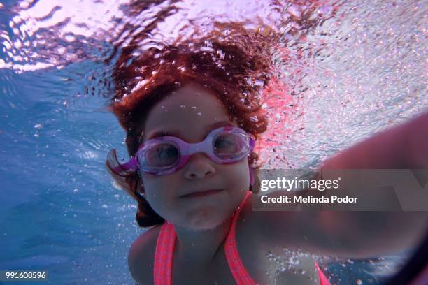 little girl underwater, appearing to take a selfie - pov or personal perspective or immersion stock pictures, royalty-free photos & images