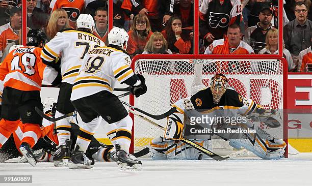 Tuukka Rask of the Boston Bruins keeps his eyes on the loose puck as teammates Michael Ryder and Matt Hunwick and Danny Briere of the Philadelphia...