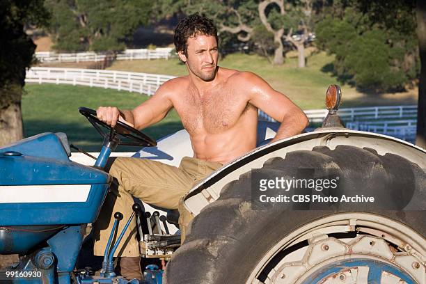 Alex O'Loughlin as Stan on his tractor at the farm in CBS Films' "The Back-up Plan."