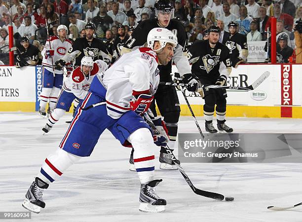 Scott Gomez of the Montreal Canadiens takes a shot in front of Evgeni Malkin of the Pittsburgh Penguins in Game Seven of the Eastern Conference...