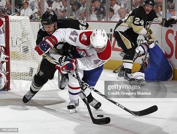 Tyler Kennedy of the Pittsburgh Penguins battles for the puck against Marc-Andre Bergeron of the Montreal Canadiens in Game Seven of the Eastern...