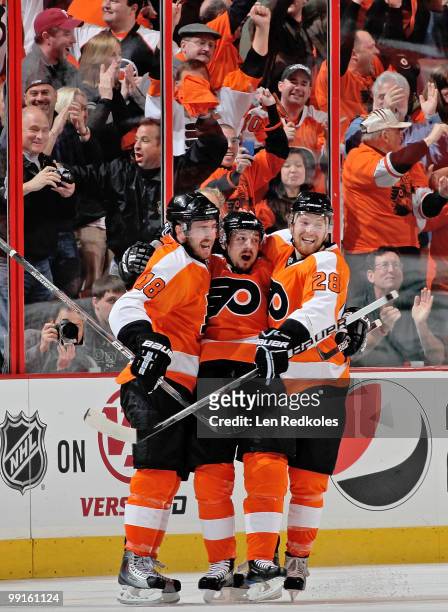 Mike Richards, Danny Briere, and Claude Giroux of the Philadelphia Flyers celebrate Briere's second-period goal against the Boston Bruins in Game Six...