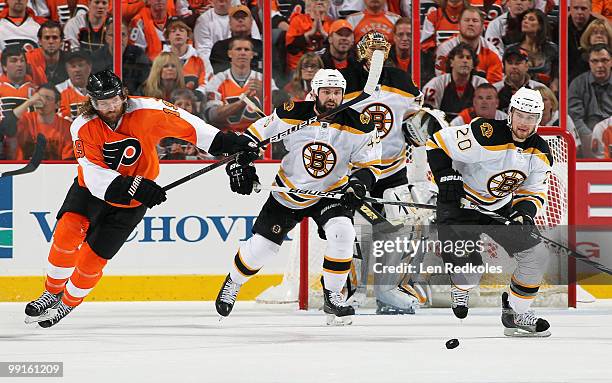 Scott Hartnell of the Philadelphia Flyers chases after the loose puck with Mark Stuart and Daniel Paille of the Boston Bruins in Game Six of the...