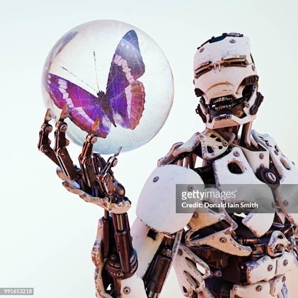 robot holds butterfly trapped inside scratched glass sphere - paperweight stock pictures, royalty-free photos & images