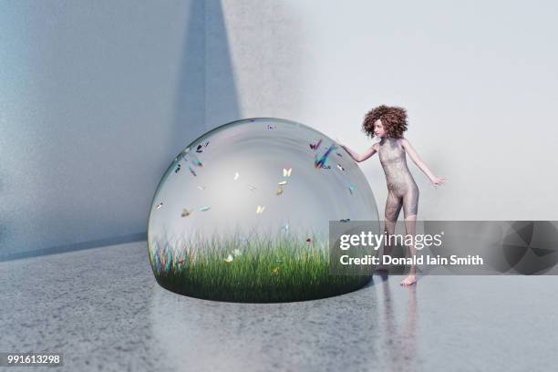 futuristic girl puts hand on giant glass globe protecting grass lawn and butterflies, with color distortion like a paperweight. - paperweight stock pictures, royalty-free photos & images