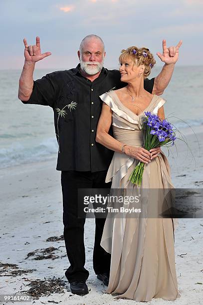 Randy Poffo , known by his ring name "Macho Man" Randy Savage, and Lynn Payne pose for photographs following their wedding on the beach May 10, 2010...