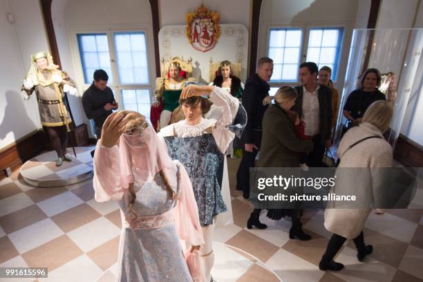 Visitors pictured in Moritzburg castle, an erstwhile hunting lodge of the House of Wettin, during the exhibition "Three hazelnuts for Cinderella" in...