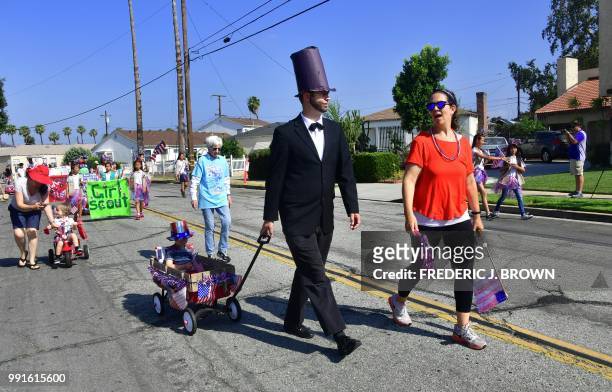 Participant dresses as former US president Abraham Lincoln during a parade in San Gabriel, California on July 4, 2018 as cities and towns across...