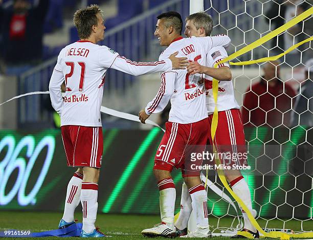 John Wolyniec of the New York Red Bulls celebrates his goal in the 64th minute with Connor Chinn and Brian Nielsen against the New England Revolution...