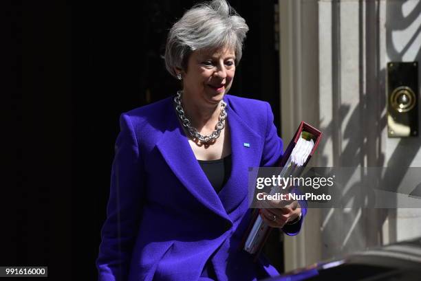 British Prime Minister Theresa May leaves 10 Downing Street to makes her way to the Parliament as she attends Prime Minister Questions session ,...