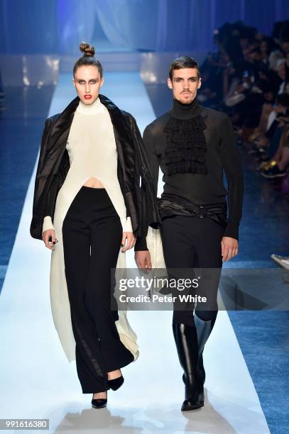 Anna Cleveland and model walk the runway during the Jean-Paul Gaultier Haute Couture Fall Winter 2018/2019 show as part of Paris Fashion Week on July...