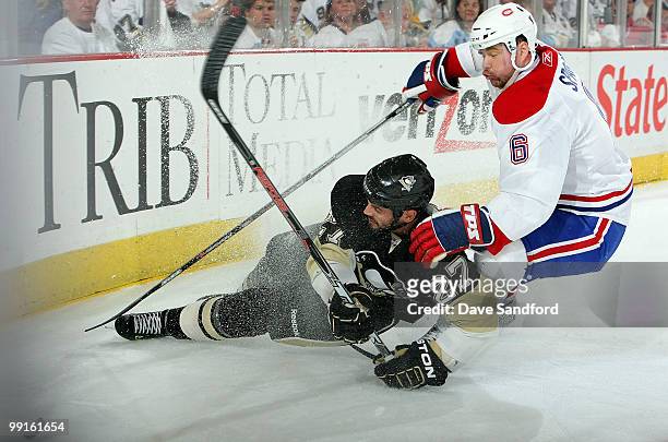 Craig Adams of the Pittsburgh Penguins is taken out by Jaroslav Spacek of the Montreal Canadiens in Game Seven of the Eastern Conference Semifinals...