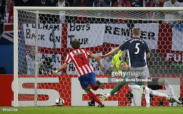 Diego Forlan of Atletico Madrid shoots the first goal during the UEFA Europa League final match between Atletico Madrid and Fulham at HSH Nordbank...