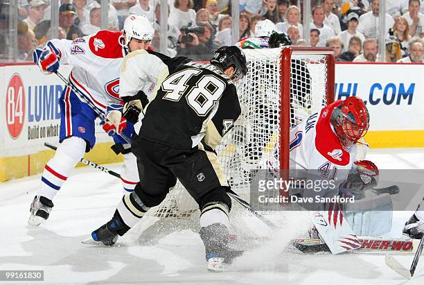 Tyler Kennedy of the Pittsburgh Penguins is stopped by Jaroslav Halak of the Montreal Canadiens as Roman Hamrlik of the Canadiens defends in Game...