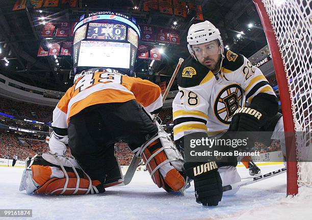 Mark Recchi of the Boston Bruins trips in the crease behind Michael Leighton of the Philadelphia Flyers in Game Six of the Eastern Conference...